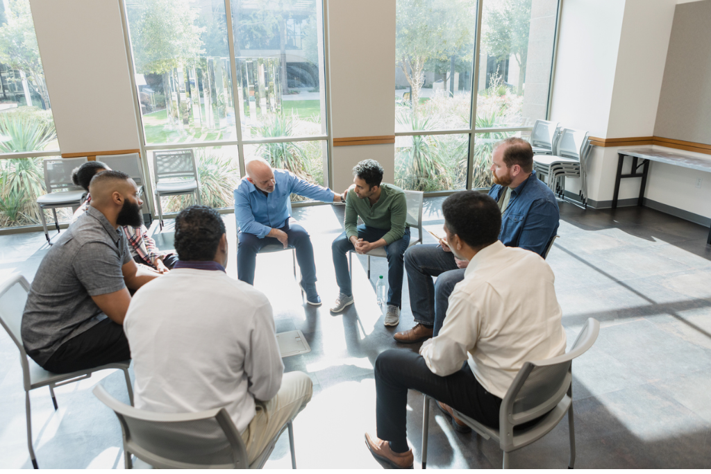 Group of men in a circle during a training session at EVRYMAN